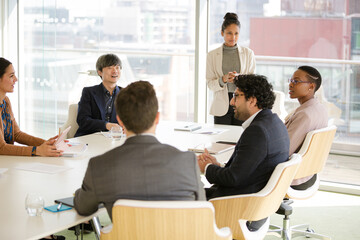 Businesswoman leading conference room meeting