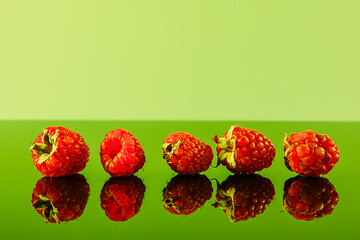 Ripe raspberries on an organic green background