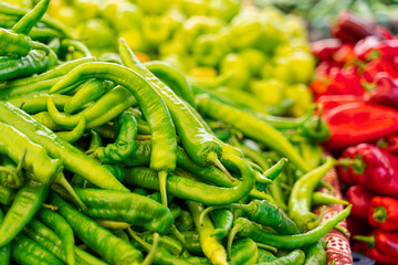 Mix of chili peppers, bell peppers, capi color assortment on vegetable market.