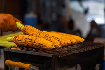 Fried corn on the grill on street. Healthy street food in Turkish market.