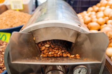 Roasting and blanching peanuts. Process of peeling peanuts in machine.