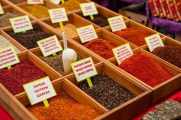 Assortment of Turkish spices and herbs in wooden bowls. Turkish market spices such as saffron, sumac and thyme. Cumin, rosemary and isot.
