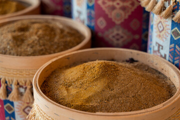 Assortment of Turkish spices and herbs in wooden bowls. Turkish market spices such as saffron, sumac and thyme. Cumin, rosemary and isot.