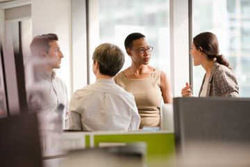 Business people talking in open plan office