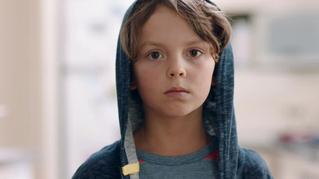 portrait happy little boy looking at camera with serious expression