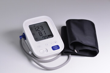 Close-up of digital blood pressure monitor with indicators of measurements on the screen. 