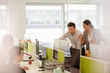 Business people brainstorming in open plan office