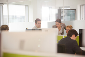 Business people brainstorming in open plan office