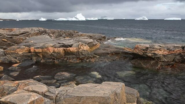 Seascape with rocks and icebergs floating in the sea, Disko Island, Greenland