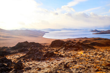 Obraz premium Nature landscape with golden field, wather, hills and blue sky with white clouds in a day or a evening