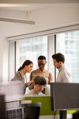 Business people talking in open plan office