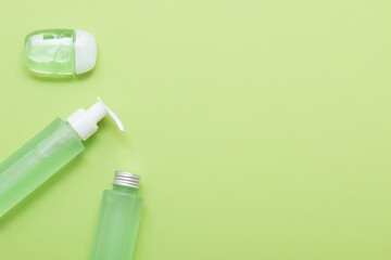 Natural cosmetic products on a green background. Mockup of cosmetic jars, bottles, tubes.