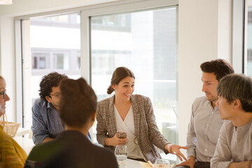 Business people enjoying sushi lunch in conference room
