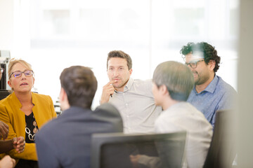 Business people brainstorming in open plan office