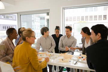 Business people enjoying sushi lunch