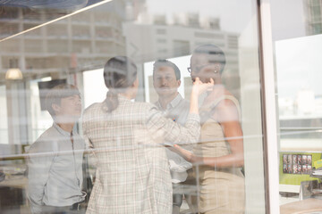 Obraz na płótnie Canvas Business people talking in open plan office