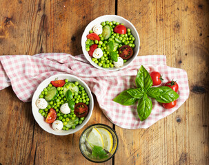 Salad vegetarian. Fresh vegetable salad with tomato, cucumber, basil, green peas, mozzarella cheese.