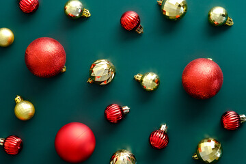 Christmas layout with golden and red baubles on green background. Flat lay, top view, overhead. Vintage style.