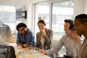 Business people enjoying sushi lunch in conference room