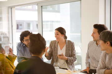 Business people enjoying sushi lunch in conference room