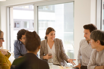 Business people enjoying sushi lunch in conference room