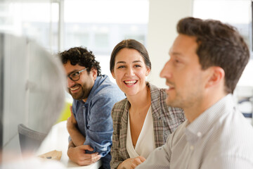 Business people enjoying sushi lunch in conference room