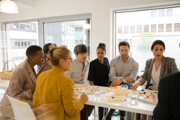 Business people enjoying sushi lunch