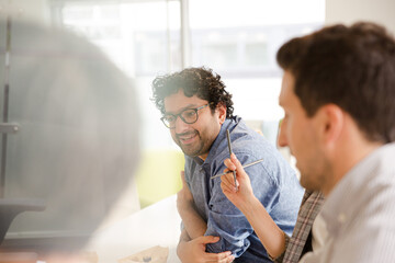 Business people enjoying sushi lunch in conference room