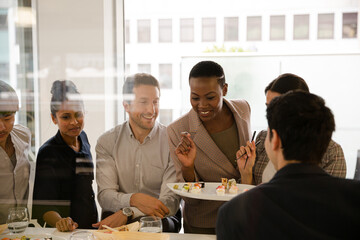 Business people enjoying sushi lunch
