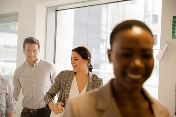 Smiling business people leaving conference room
