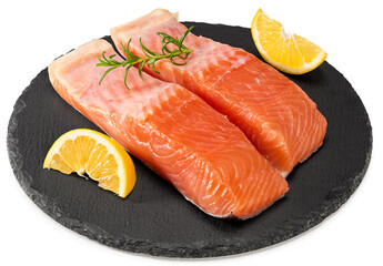 Red fish. Raw salmon fillet with rosemary and lemon on black round stone plate isolate on white background. Clipping path and full depth of field.