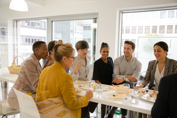 Business people enjoying sushi lunch