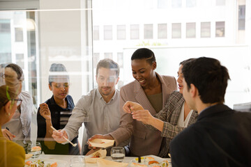 Business people enjoying sushi lunch