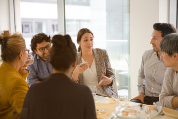 Business people enjoying sushi lunch in conference room