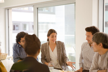 Business people enjoying sushi lunch in conference room