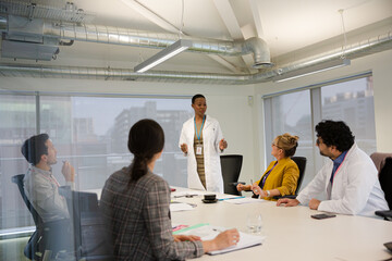 Businesswoman leading conference room meeting