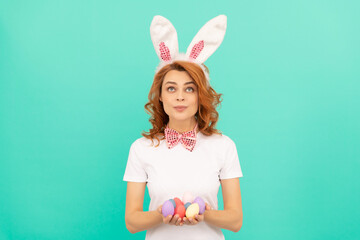 happy redhead woman in bunny rabbit ears with painted eggs, easter spring holiday