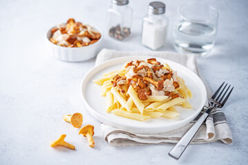 Chanterelle onion fried creamy pasta in a plate