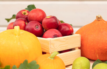 Fresh ripe red apples in a wooden box, autumn harvest.