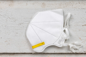 N95 protective mask on a white wooden table