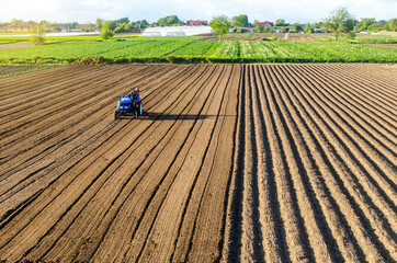 Tractor on farmland field. Farm work. Milling soil, Softening the soil before planting new crops....