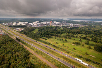 Fototapeta na wymiar Highway from the air with golf course and refinery in the background