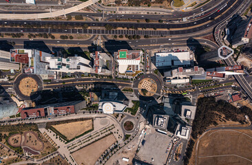 Birds eye view of rooftop of building and skyscrapers with empty street and road in Santa Fe which is the New neighbourhood in Mexico City during day