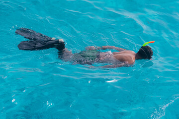 A male tourist swims in a mask and fins on the Red Sea, Egypt, Sharm el Sheikh.