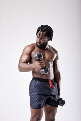 Fototapeta na wymiar very strong young guy bodybuilder of african appearance doing exercises with dumbbells isolated on white background. Fitness athlete male with muscular body. Sports and fitness. portrait