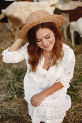 Putdoor portrait of young happy woman with goat