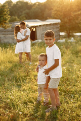 Fototapeta premium Cute family playing in a summer field
