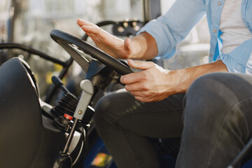 Male sitting comfortably on a big blue tractor