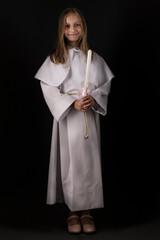 Young girl dressing for her First Communion