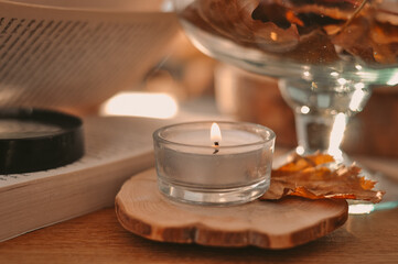 Autumn composition with golden leaves and candle 